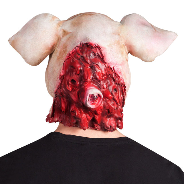 Achterzijde van het latex varkensmasker met rood vleesreliëf en een uitstekend oog