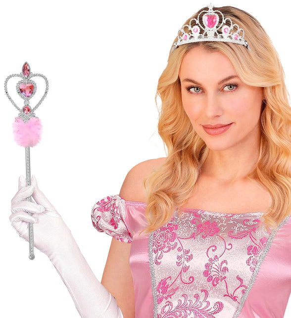 Dame met witte handschoen houdt toverstaf prinsessen met marabou omhoog bij roze satijnen jurk