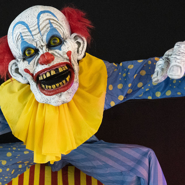 Detail van de clownskop met gele halskraag, rode grijns en gele tanden