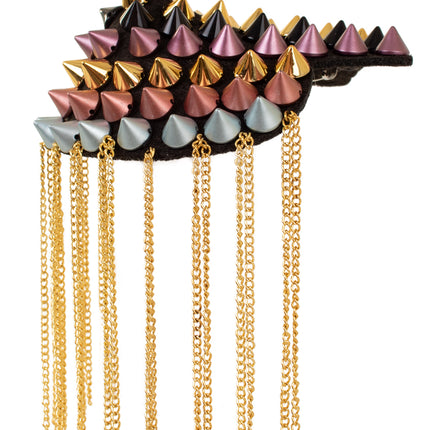 Detail van epaulet met spikes: rijen studs per kleur en franje van gouden kettinkjes langs de onderrand
