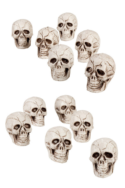 Doodskoppen deco: twaalf witte schedels van 4x3 cm met gebarsten reliëf en open kaak voor Halloween
