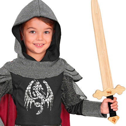 Jongen in ridderoutfit houdt het houten ridderzwaard omhoog op een ridderfeest