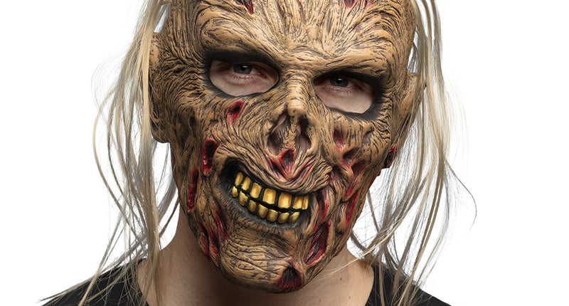 Latex hoofdmasker Zombie Grumble met blonde haarlokken en gele tanden, gedragen voor Halloween