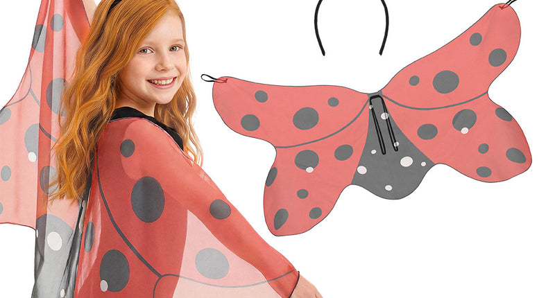 Lieveheersbeestje set Dotty met rood gestippelde vleugels en sprieten met pompons, gedragen door een meisje voor carnaval