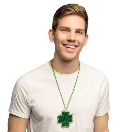 Shamrock ketting groen met klavertje vier hanger, gedragen over een wit T-shirt voor St. Patrick's Day